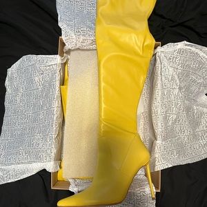 Yellow over the knee boots. No rips, tears of stains.